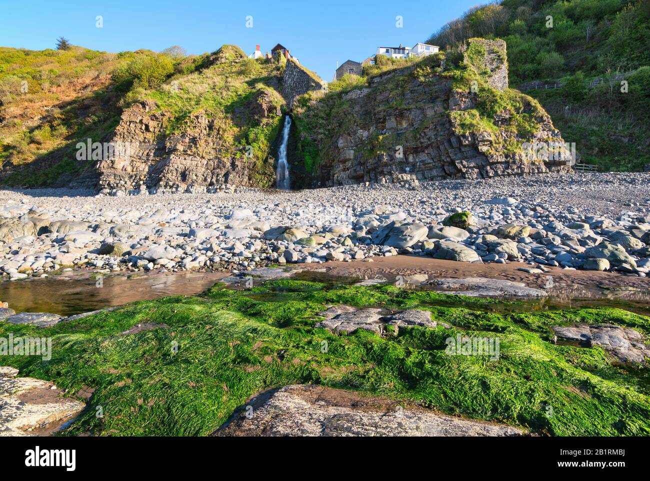 Coastal waterfall on the beach at Bucks Mills at the bottom of the unique, historic village, Geographical feature, coastal life, North Devon, UK Stock Photo