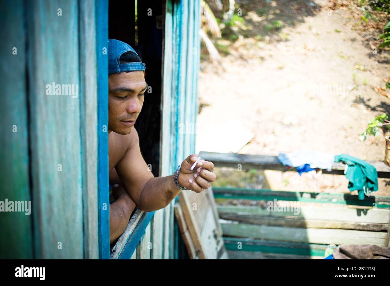 Man in the Window, Terra Preta Community, Iranduba, Amazonas, Brazil Stock Photo