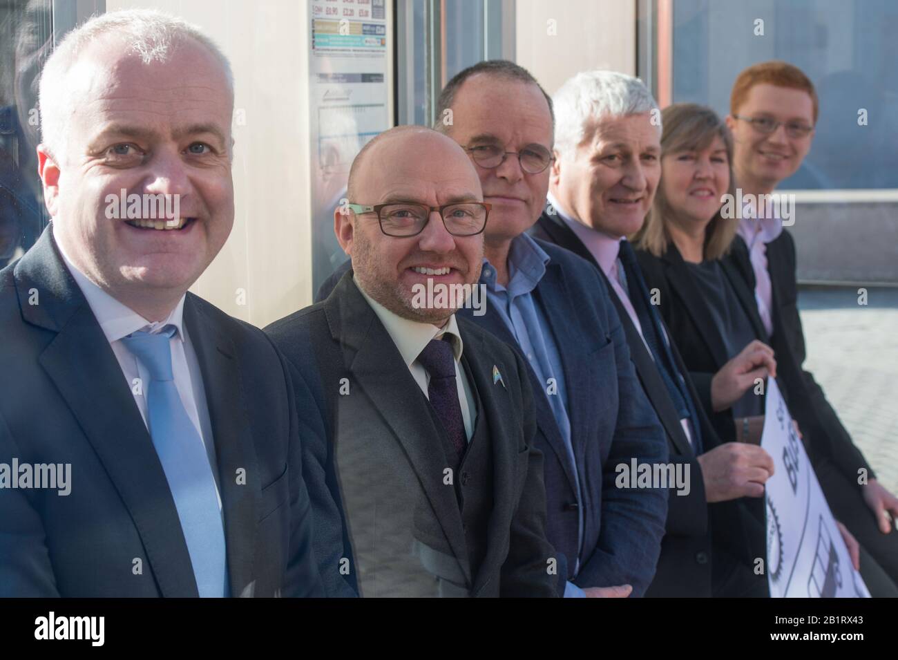 Edinburgh, UK. 27 February 2020. Pictured: L-R) Mark Ruskell MSP; Patrick Harvie MSP; Andy Wightman MSP; John Finnie MSP; Alison Johnstone MSP; Ross Greer MSP. Ahead of the budget debate this afternoon Scottish Greens Parliamentary Co-Leaders Alison Johnstone MSP and Patrick Harvie MSP along with the Green MSP group will stage a photocall outside the Scottish Parliament to celebrate their free bus travel for under 19s budget win. The Scottish Greens yesterday announced that a deal had been struck on free bus travel, more money for councils, extra resource for community safety and an additi Stock Photo