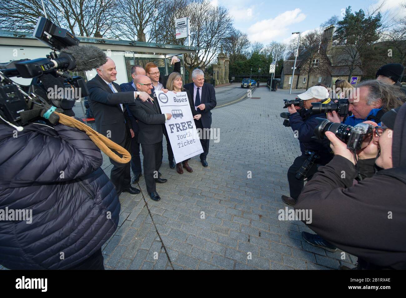 Edinburgh, UK. 27 February 2020. Pictured: (L-R being photographed) Mark Ruskell MSP; Patrick Harvie MSP; Andy Wightman MSP; Ross Greer map; Alison Johnstone MSP; John Finnie MSP. Ahead of the budget debate this afternoon Scottish Greens Parliamentary Co-Leaders Alison Johnstone MSP and Patrick Harvie MSP along with the Green MSP group will stage a photocall outside the Scottish Parliament to celebrate their free bus travel for under 19s budget win. The Scottish Greens yesterday announced that a deal had been struck on free bus travel, more money for councils, extra resource for community Stock Photo