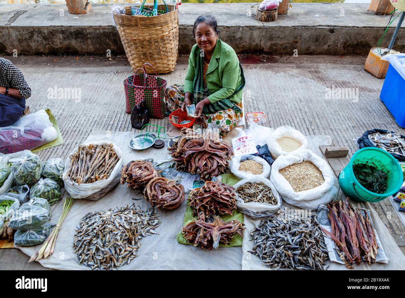 A Local Woman Sells Dried Fish In The Central Market, Loikaw, Kayah State, Myanmar. Stock Photo