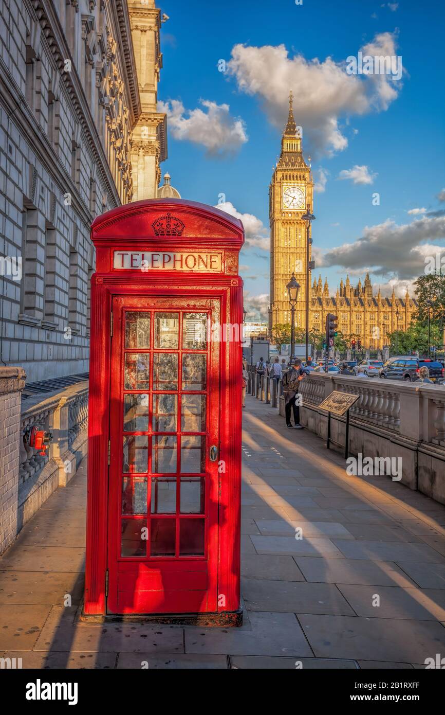 London with red phone booth against Big Ben in England, UK Stock Photo