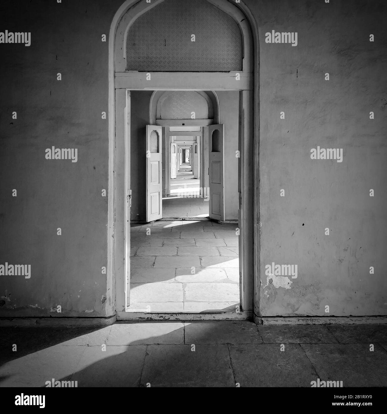 Black and white photo of a continuance of doors within doors view in an