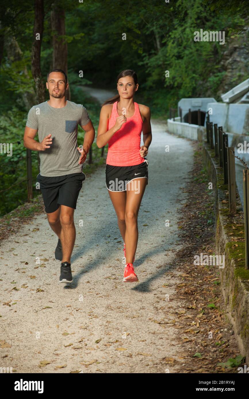 active young couple running in park Stock Photo