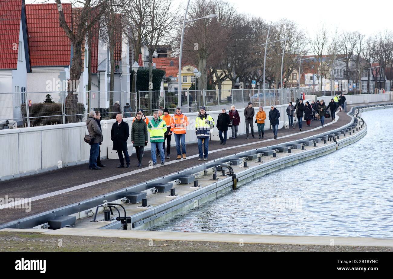 27 February 2020, Mecklenburg-Western Pomerania, Warnemünde: The promenade at the new storm surge barrier at the southern end of Alter Strom has been opened to the public after a good two years of construction. The 500-metre long protective wall was officially handed over on 10.01.2020, and now the promenade along the wall is also finished and accessible. Photo: Bernd Wüstneck/dpa-Zentralbild/ZB Stock Photo