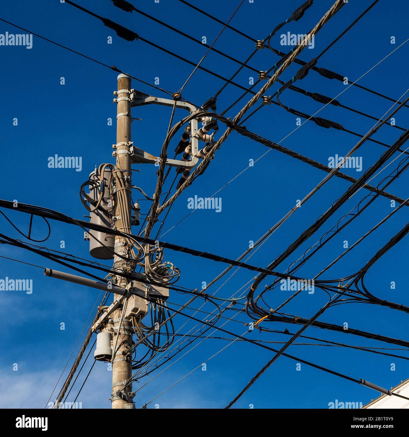 Electric power industry. Characteristic utility and transmission pole and overhead power lines in Japan Stock Photo