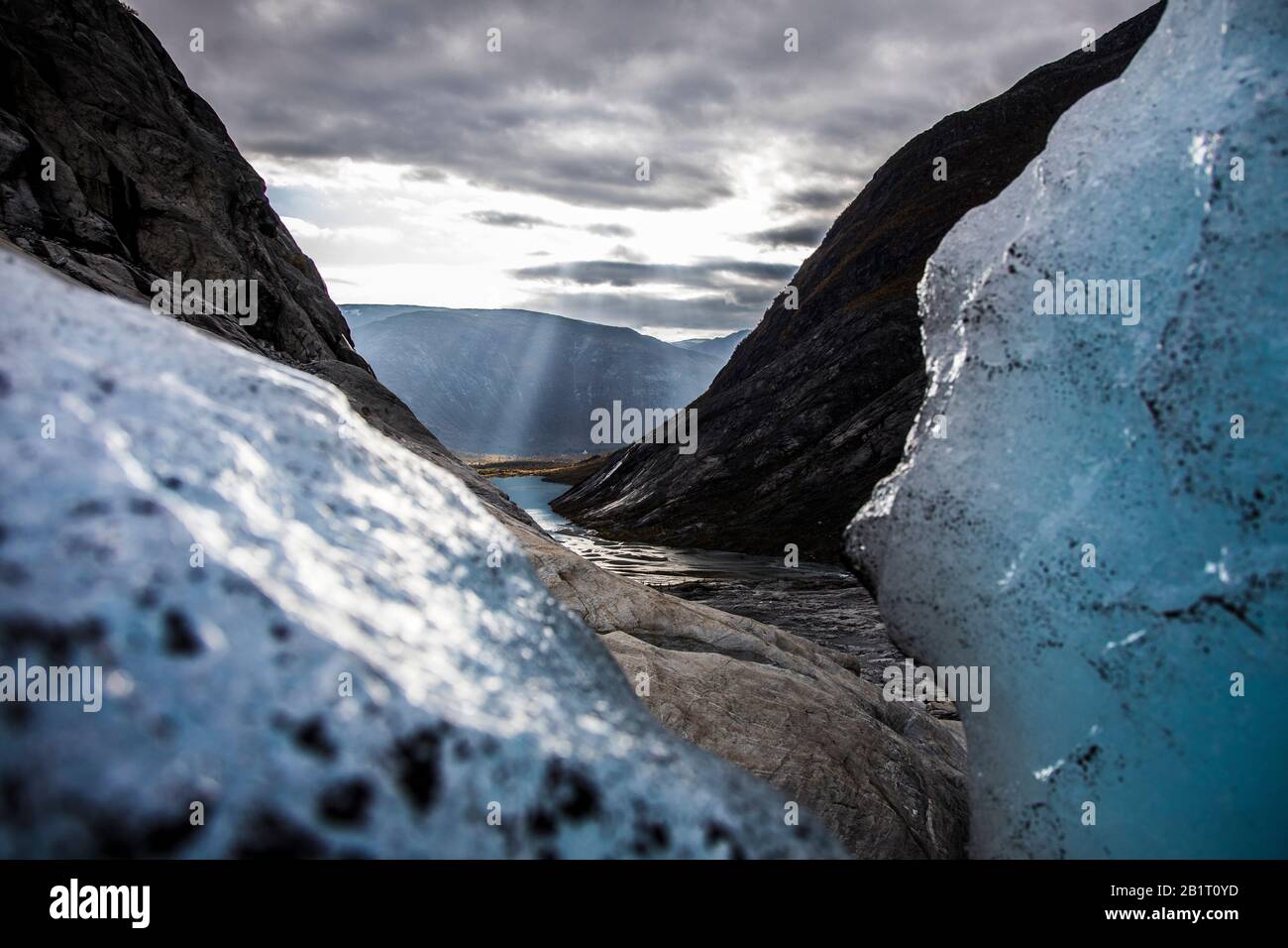 Looking out from the glacier to the light coming trough the clouds Stock Photo