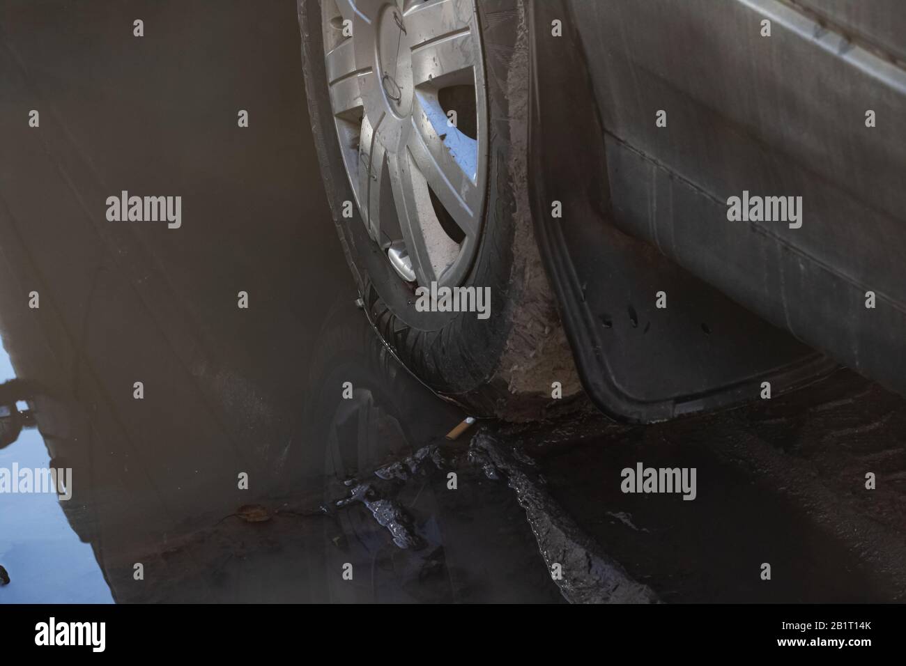 Car wheel stuck in mud close up Stock Photo Alamy