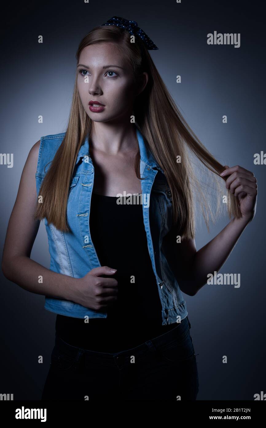 Moody studio portrait of a beautiful young brunette woman with long hair Stock Photo