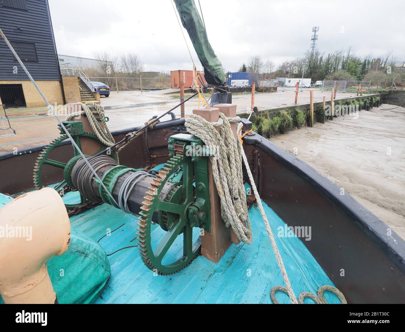 Sittingbourne, Kent, UK. 27th Feb, 2020. Restoration of the historic 100 year old Thames Sailing Barge Raybel built in 1920 is currently underway at Milton Creek. Sittingbourne developed from the creek and the brick building industry, which relied heavily on barges built in the town for transport of goods. Raybel is currently situated at the head of the creek alongside the Dolphin Sailing Barge Museum Trust, which has just moved to the site with a newly constructed building that is due to officially open next year (the original museum burnt down in 2008). Credit: James Bell/Alamy Live News Stock Photo