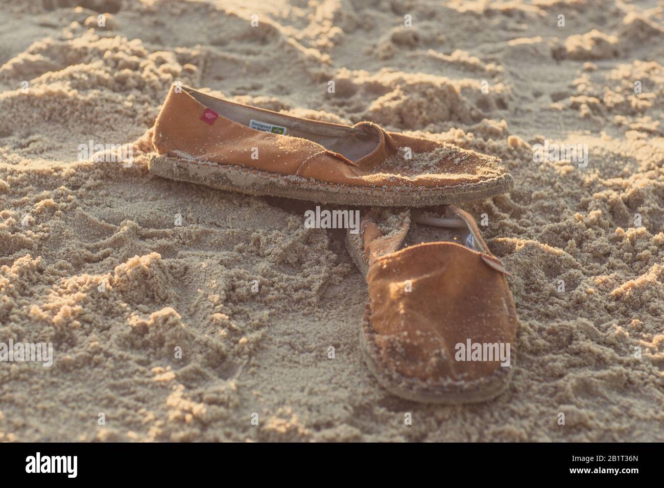 Canvas shoes on a sandy beach Stock Photo