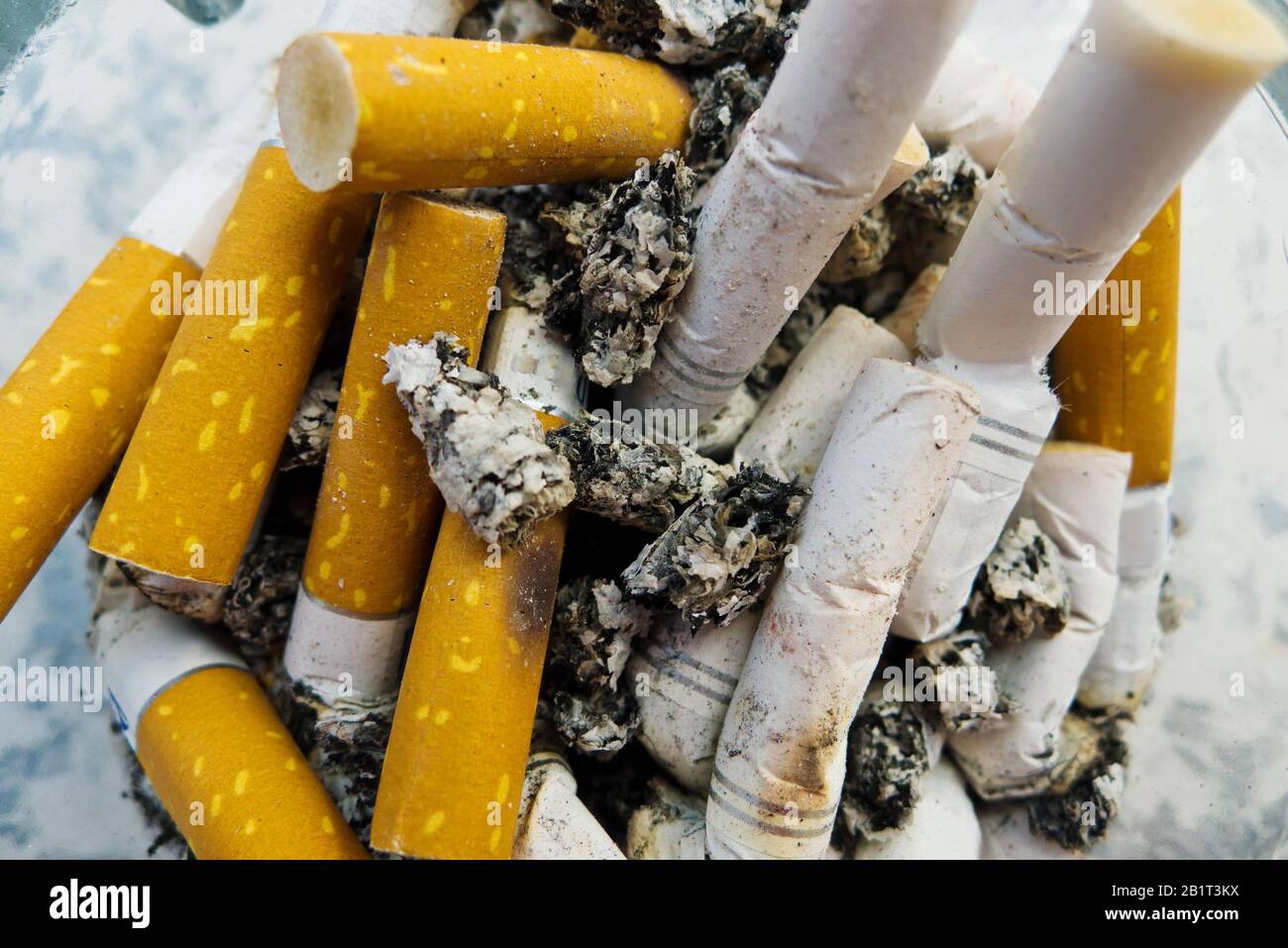 Zigarettenstummel in einem Aschenbecher, Symbolfoto fuer Kettenrauchen und Gesundheitsgefahr Stock Photo