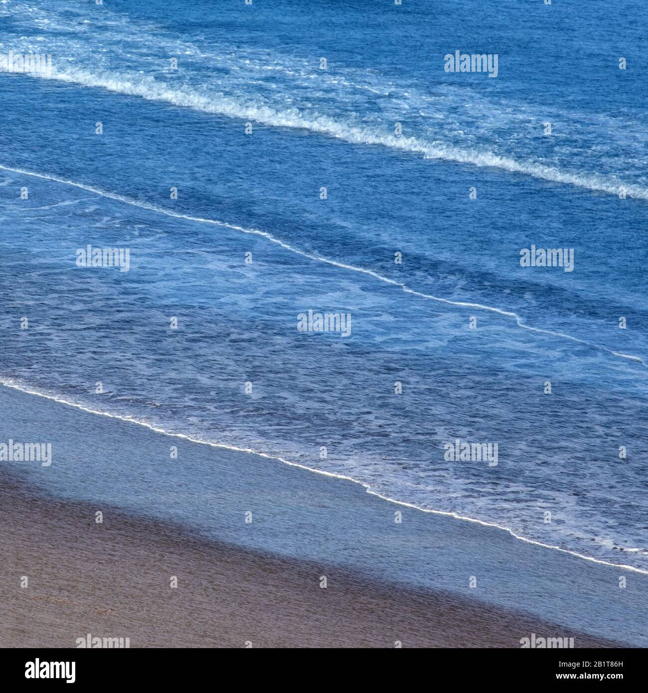 Abstract sea image of incoming tides taken from on the shore at Penbryn Beach in Cardigan Bay Wales UK Stock Photo