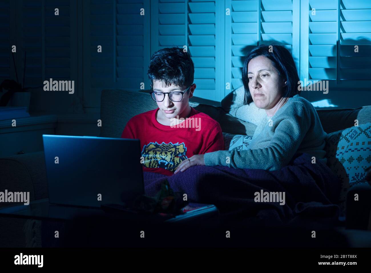 Mother and  son watching online  movies together  on laptop computer at home Stock Photo