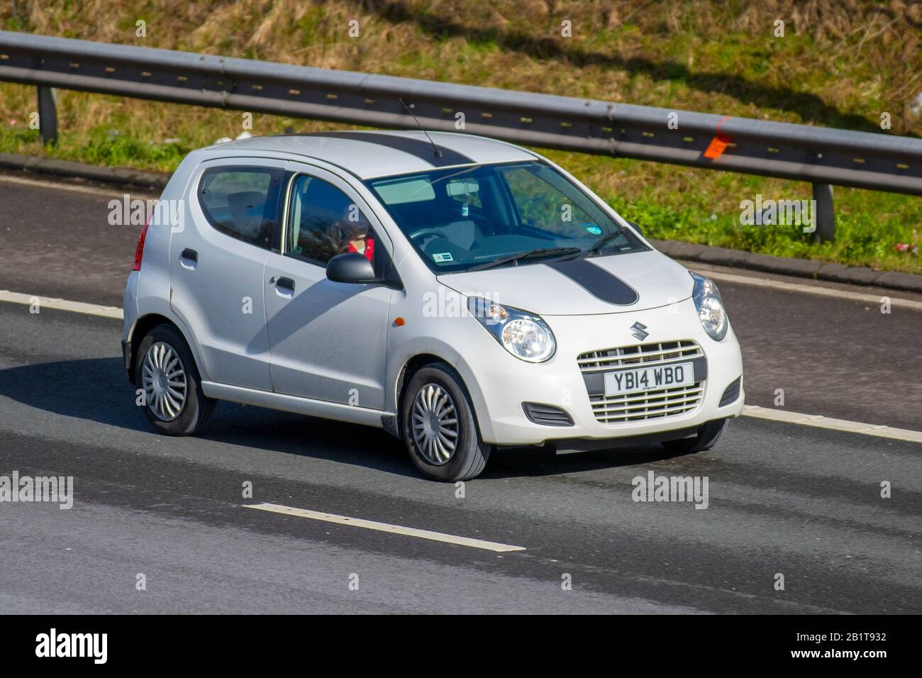 2014 white Suzuki Alto SZ3; UK Vehicular traffic, transport, modern vehicles, saloon cars, vehicles, vehicle, uk roads, motors, motoring on the M6 motorway highway Stock Photo