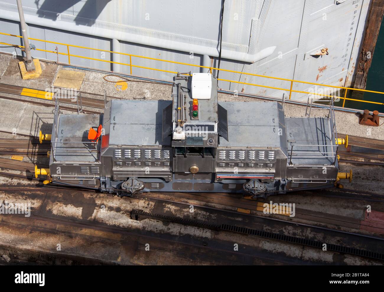 The view from above of an electric locomotive known as the mule that is guiding ships through the narrow canal (Panama). Stock Photo