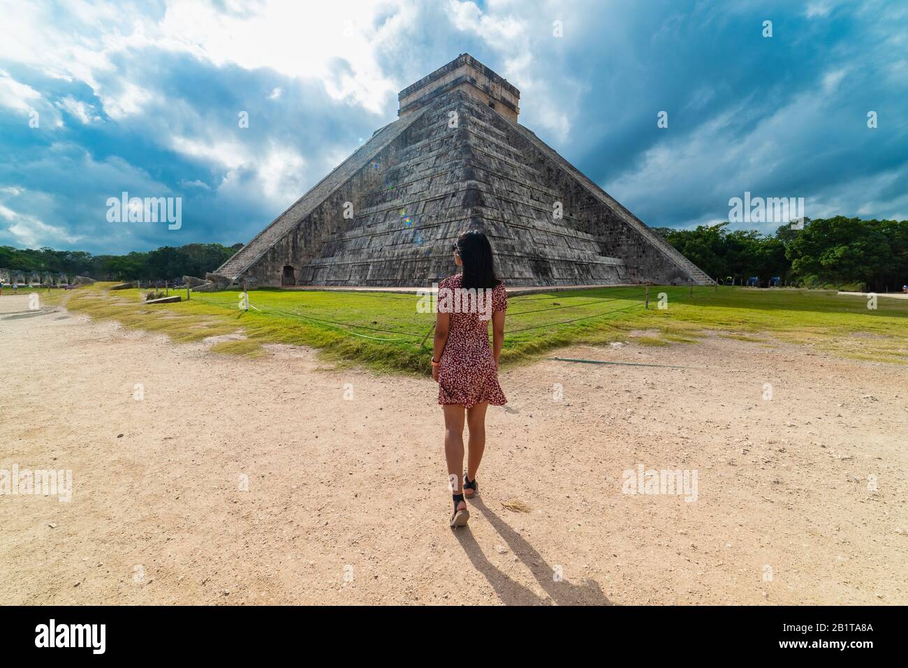 Woman with Chichen Itza Mayan Ruins in the background Yucatan Mexico Stock Photo