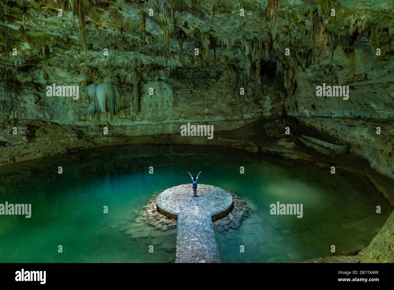Woman enjoying the view of Suytun Cenote from the top Yucatan Mexico North America Stock Photo