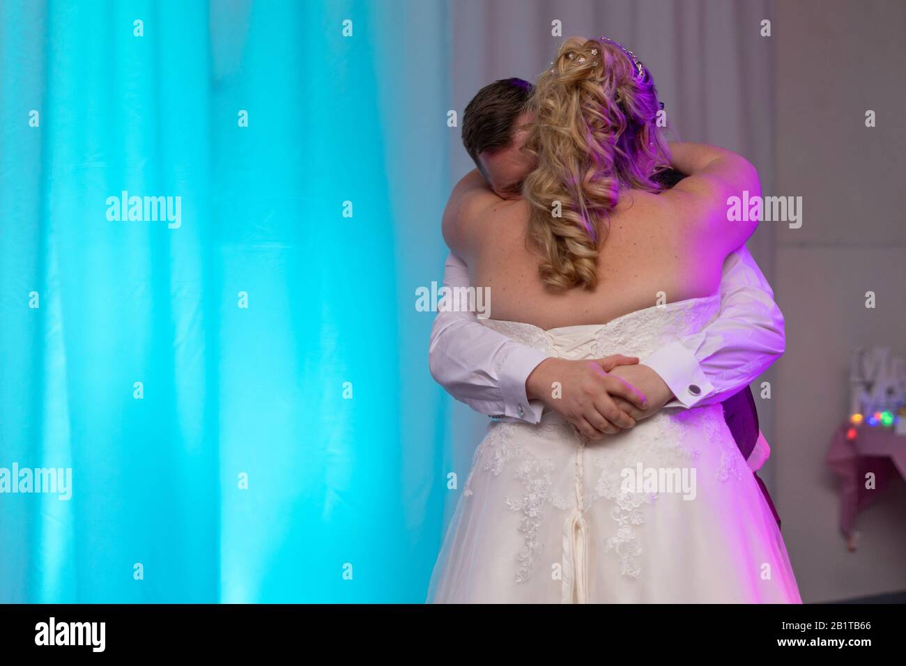 a bride and groom dancing their first dance on their wedding day at their wedding reception Stock Photo