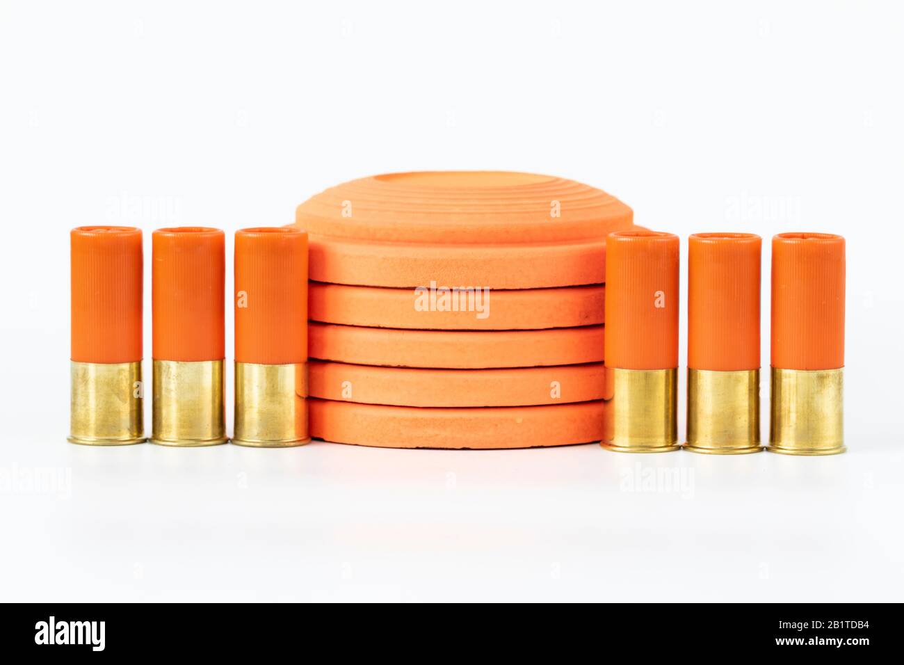 Clay pigeons and shotgun cartridges on a white background Stock Photo
