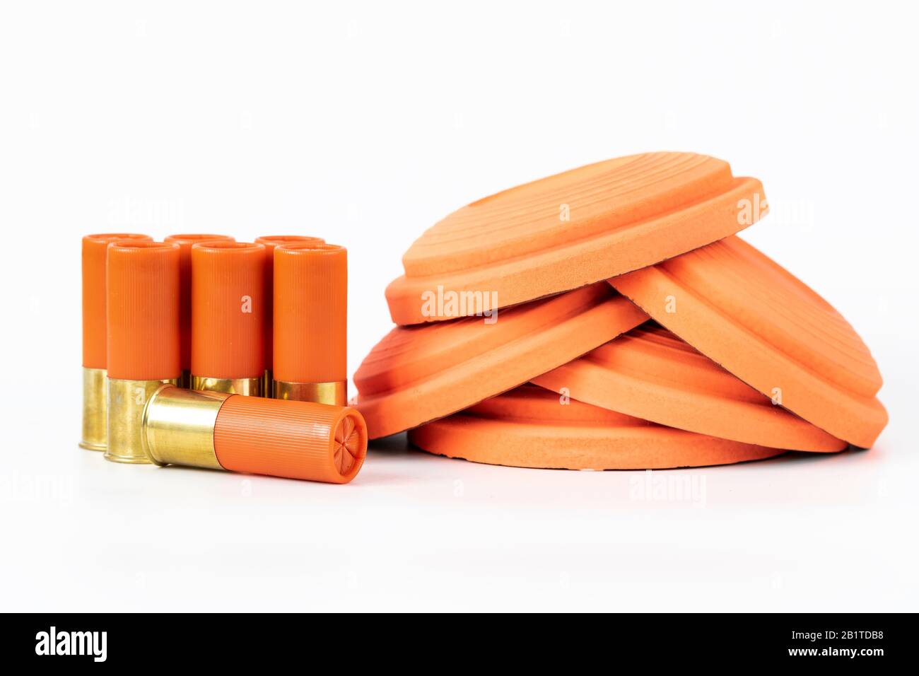 Clay pigeons and shotgun cartridges on a white background Stock Photo