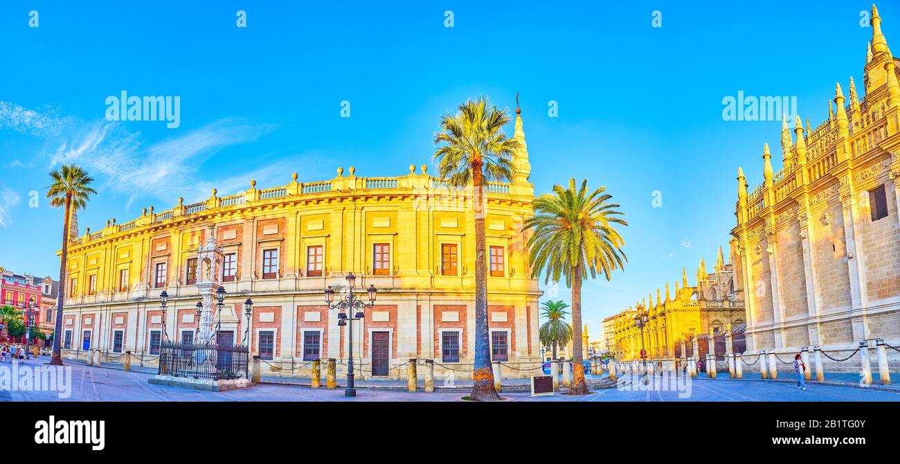 SEVILLE, SPAIN - OCTOBER 1, 2019: Panoramic view on the Plaza del Triunfo square with monumental Cathedral and the facade of the General Archive of th Stock Photo