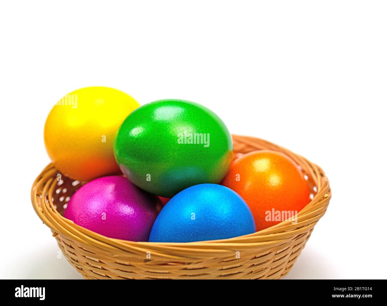 Colorful Easter eggs in basket against white background Stock Photo - Alamy