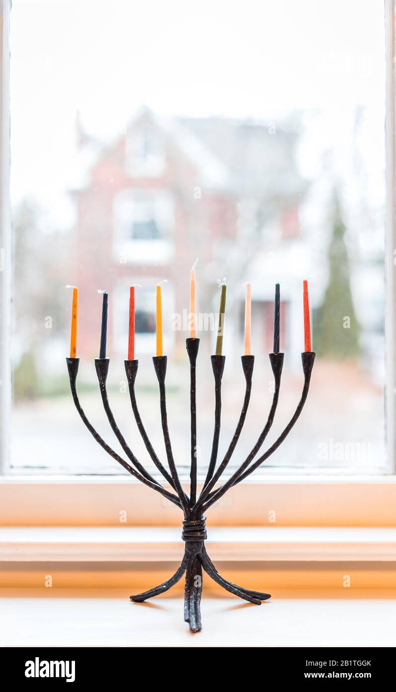 Menorah with unlit candles for Hanukkah celebrations in a window Stock