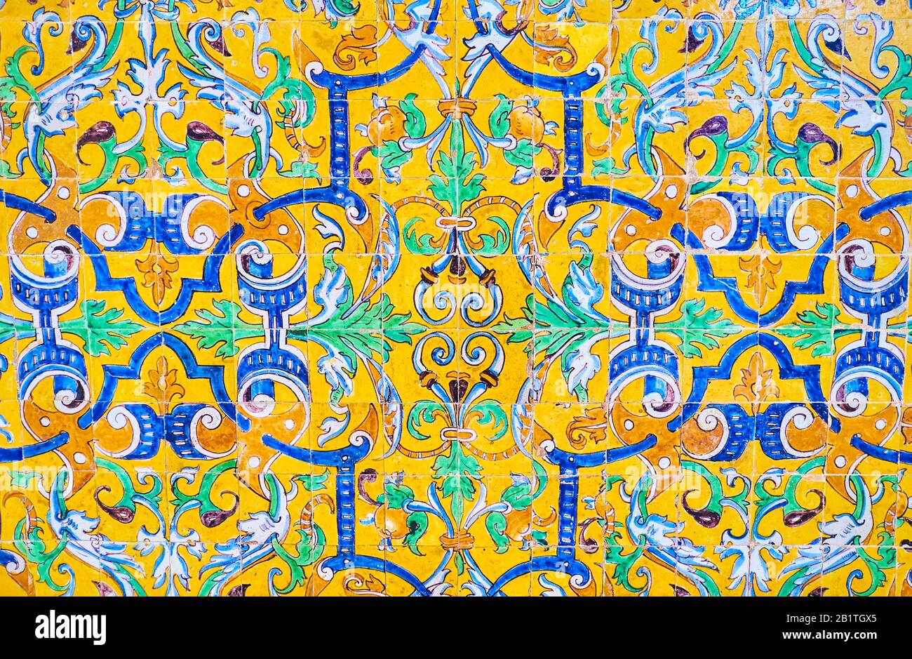 The traditional Andalusian style glazed tiles on the facade of Alcazar Palace with classic floral pattents, Seville, Spain Stock Photo