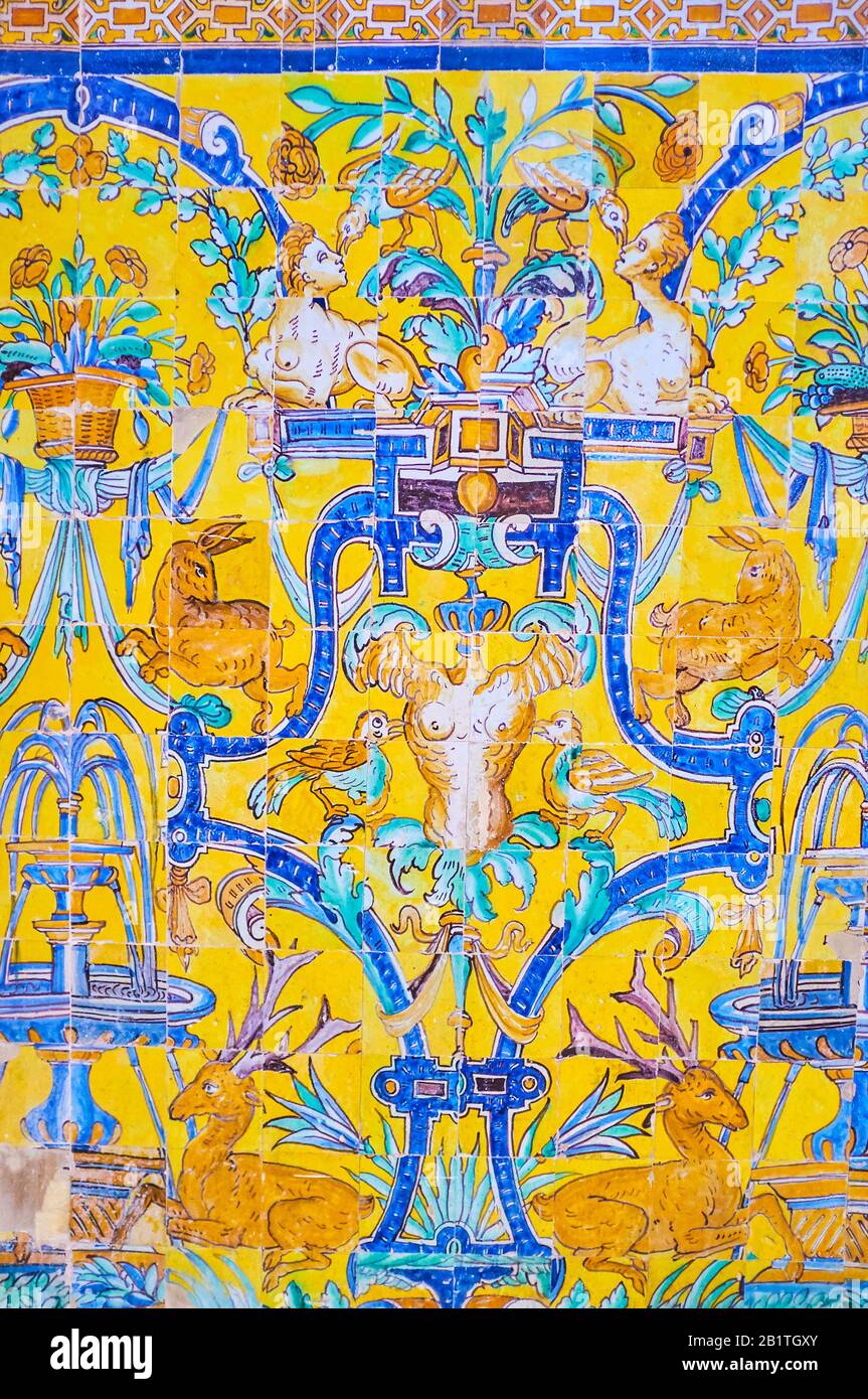 The historical tiled wall in Alcazar Palace with Andalusian animalistic and floral patterns, the classical style in tile art, Seville, Spain Stock Photo