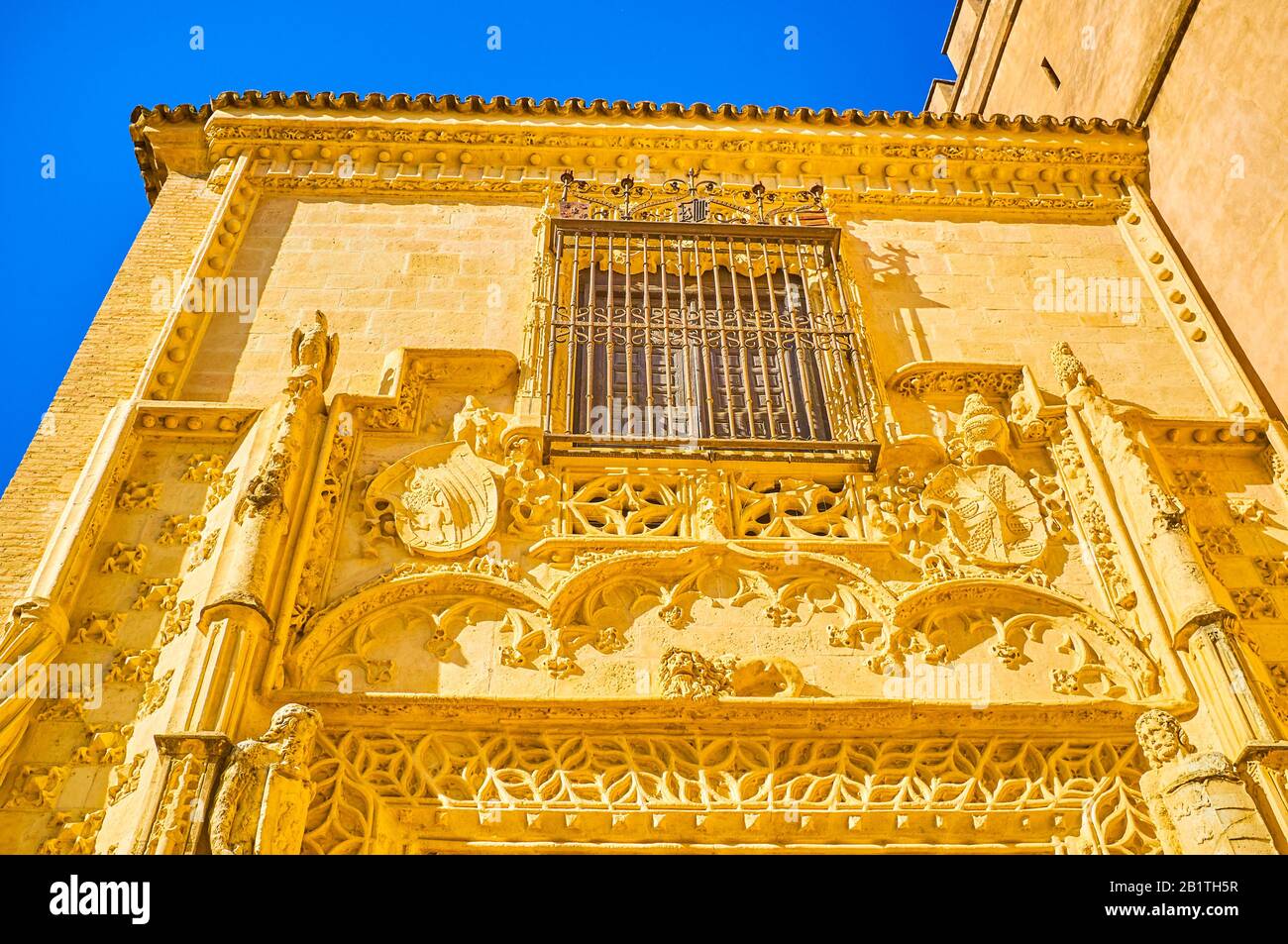 SEVILLE, SPAIN - OCTOBER 1, 2019: The beautiful stone carved decorations on Marchena Gates in mudejar style, on October 1 in Seville Stock Photo