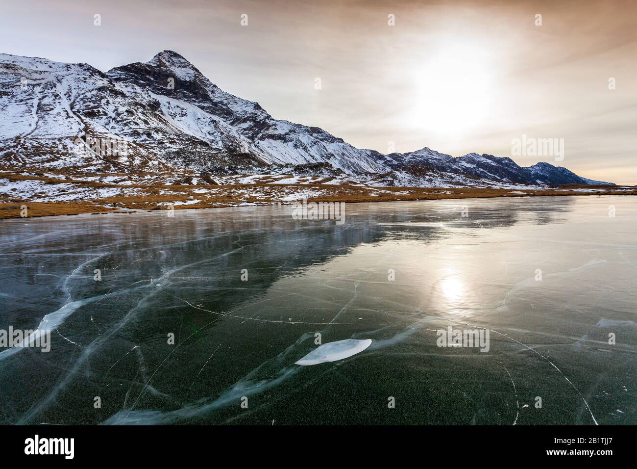 Valmalenco (IT) - Frozen lake with Pizzo Scalino on the bottom Stock Photo