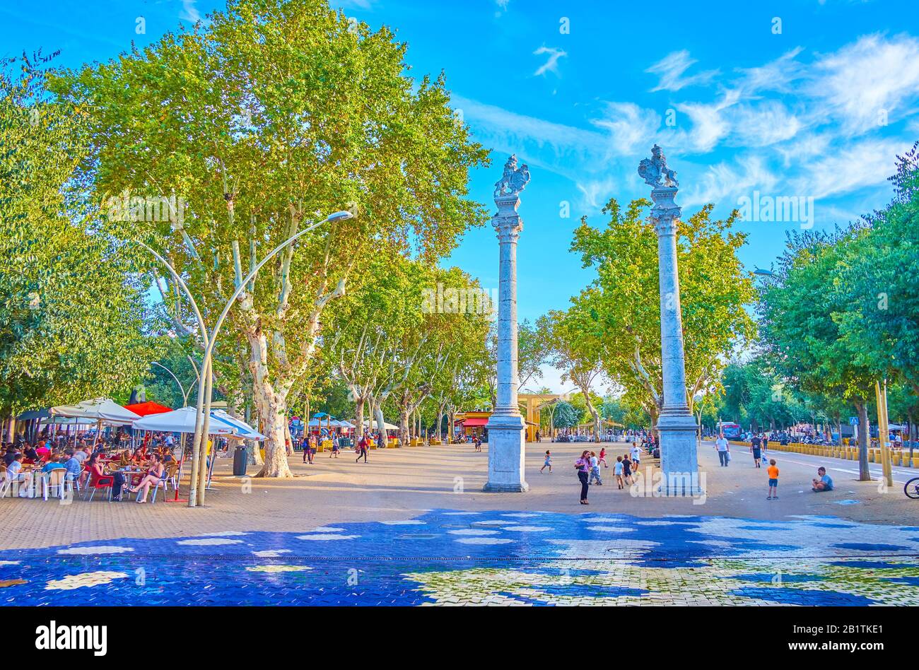 SEVILLE, SPAIN - OCTOBER 1, 2019: The famous La Alameda square with columns and sculptures of the lion atop and rows of white poplar trees on the back Stock Photo