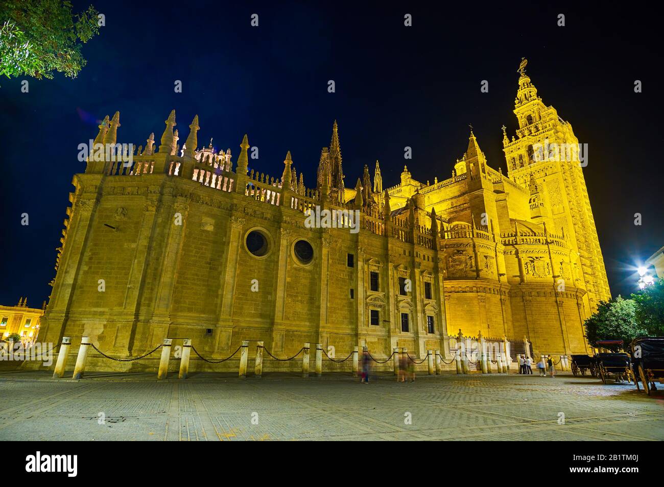 The amazing night illumination of huge Seville Cathedral, the most notable landmark of the city, Spain Stock Photo