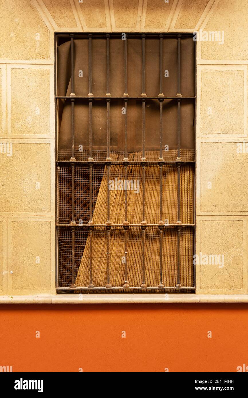 Window with bars and stone surround in Vélez-Málaga, Spain Stock Photo