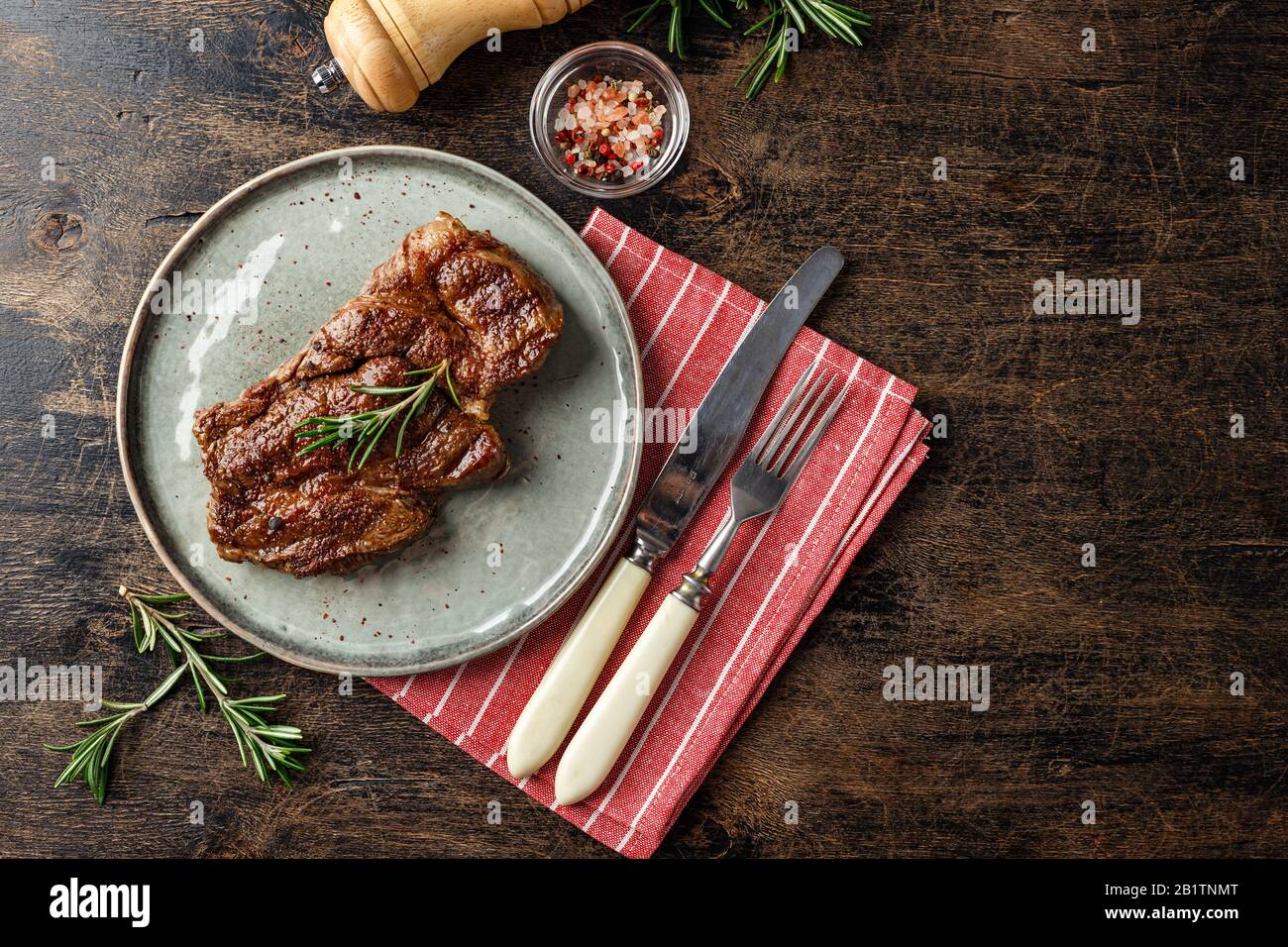 Fresh grilled beef steak Prime Black Angus Chuck roll steak on a dish on a wooden table. Top view, place for text Stock Photo
