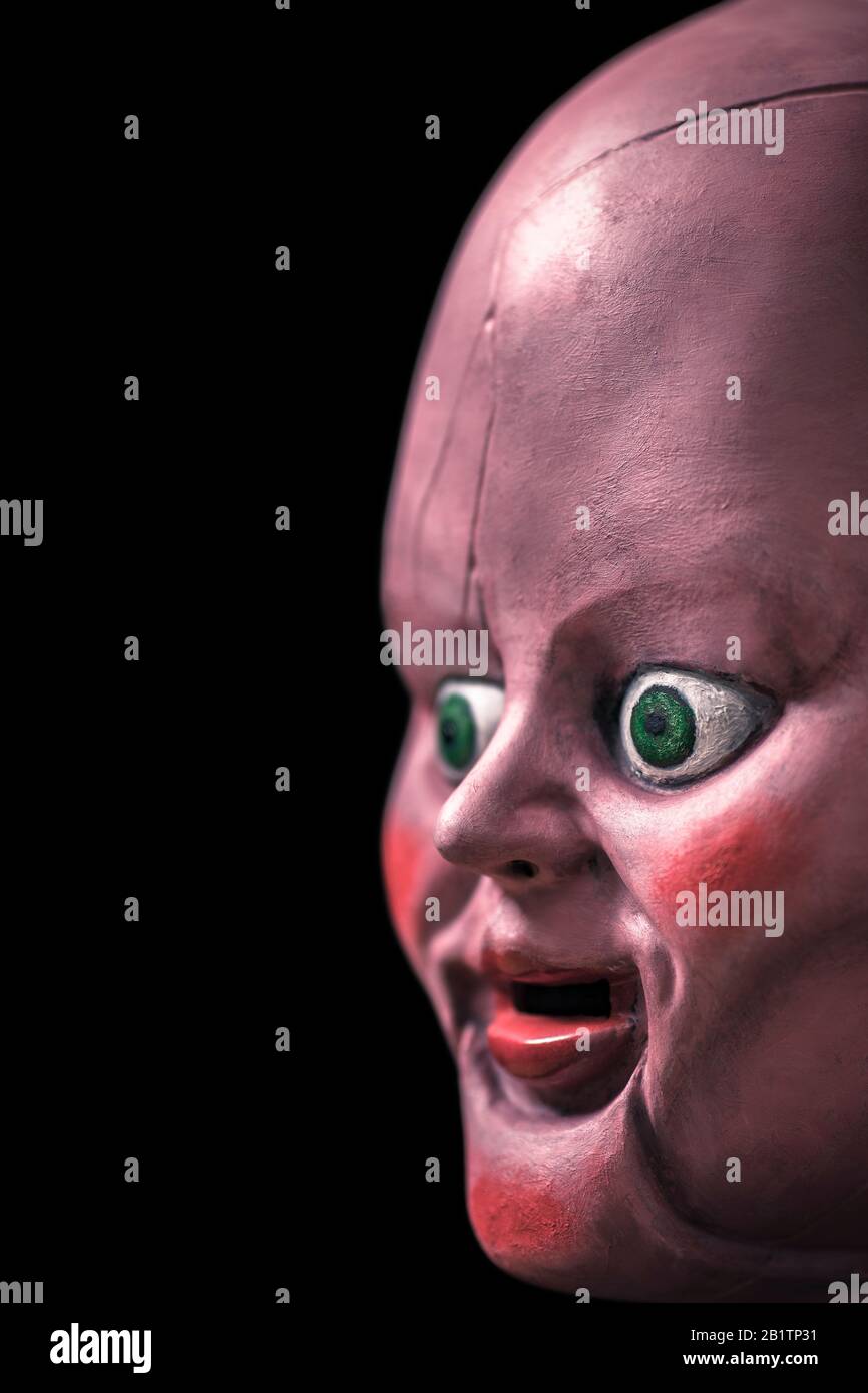 Creepy doll head in the dark Stock Photo