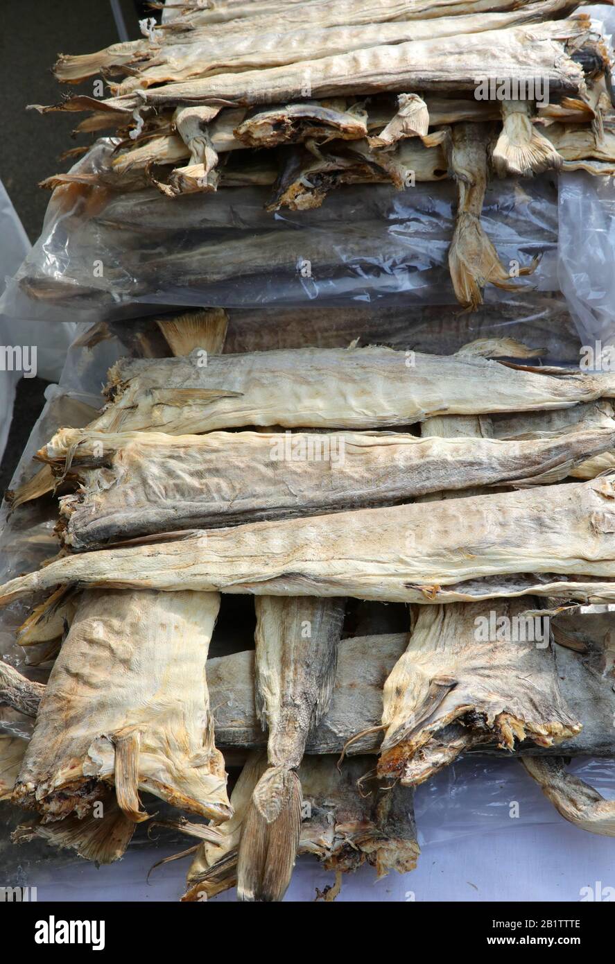 many dried headless stockfish dried in the sun for sale at sih market Stock Photo