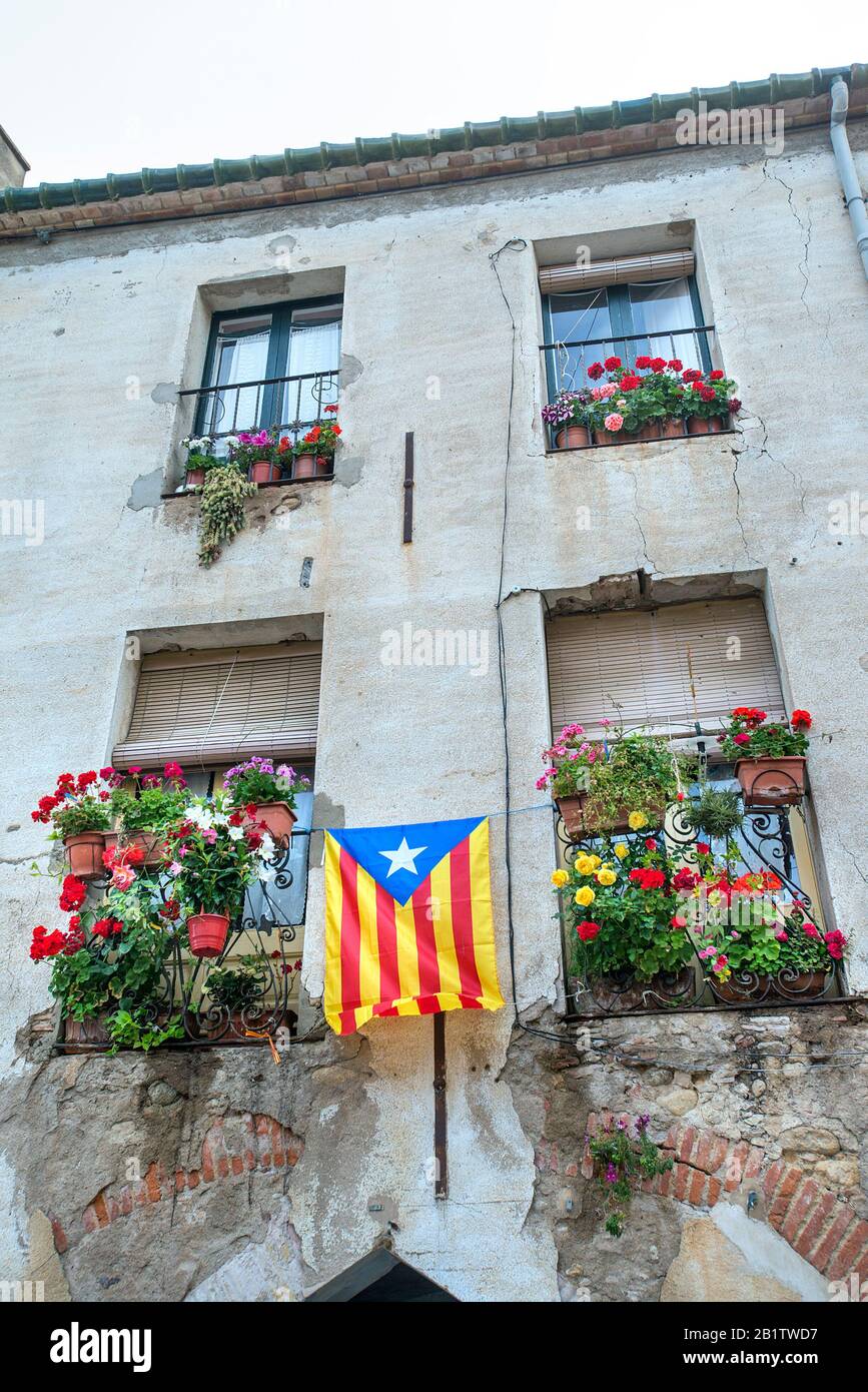 House facade with Catalan independence flag, Peralada, Girona, Spain Stock Photo