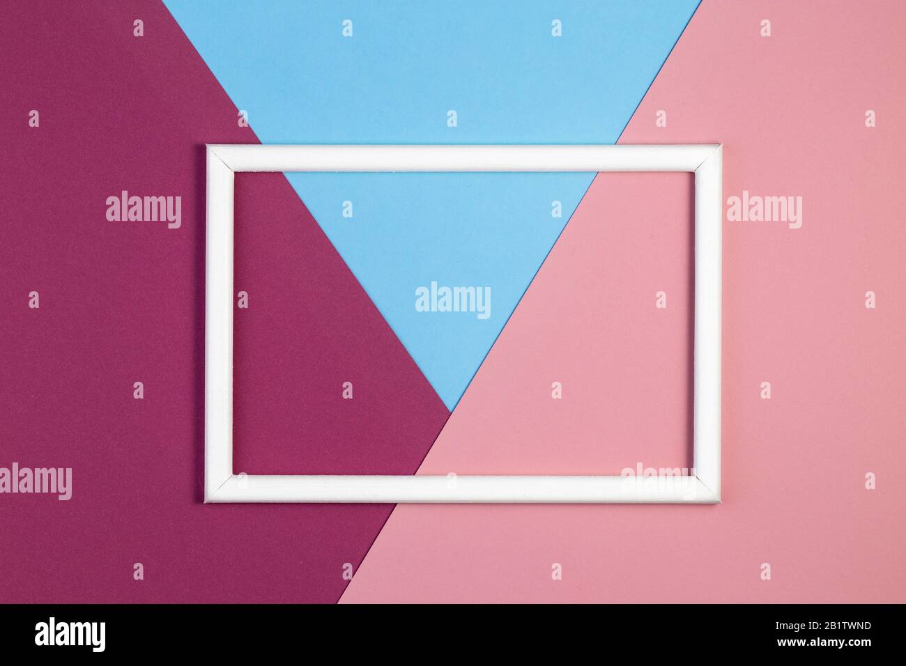 Geometry background minimal concept. Multicolored paper with empty picture frame. Creative flat layout with copy space. Stock Photo
