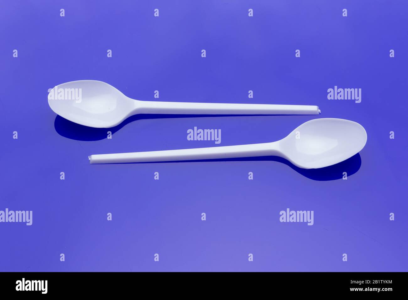 Small coffee spoon and plastic fork and white Small objects used to