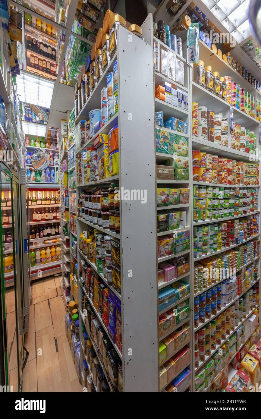 Narrow moroccan-owned well-stuffed food and convenience store with products packed up to the ceiling Stock Photo