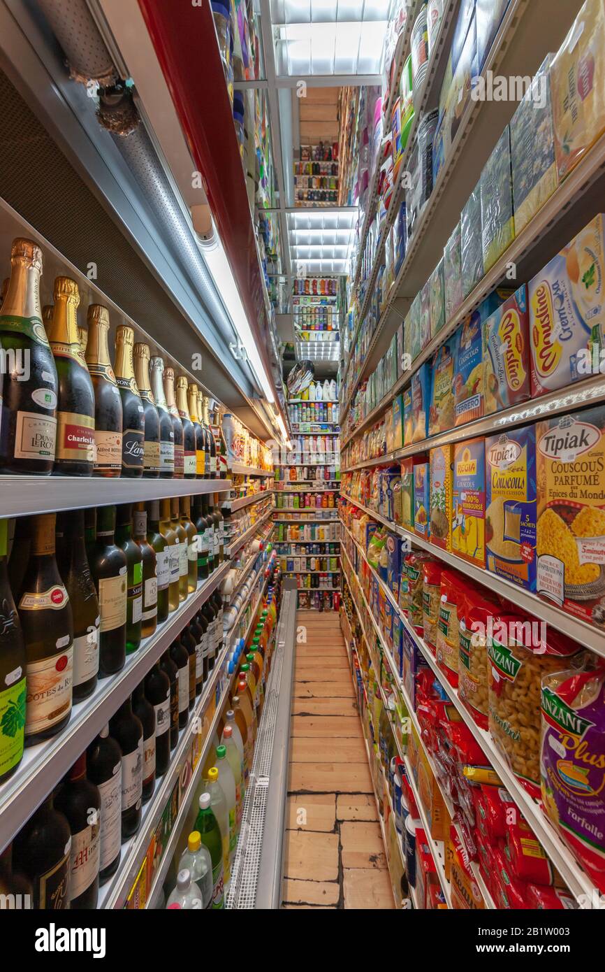 Narrow moroccan-owned well-stuffed food and convenience store with products packed up to the ceiling Stock Photo
