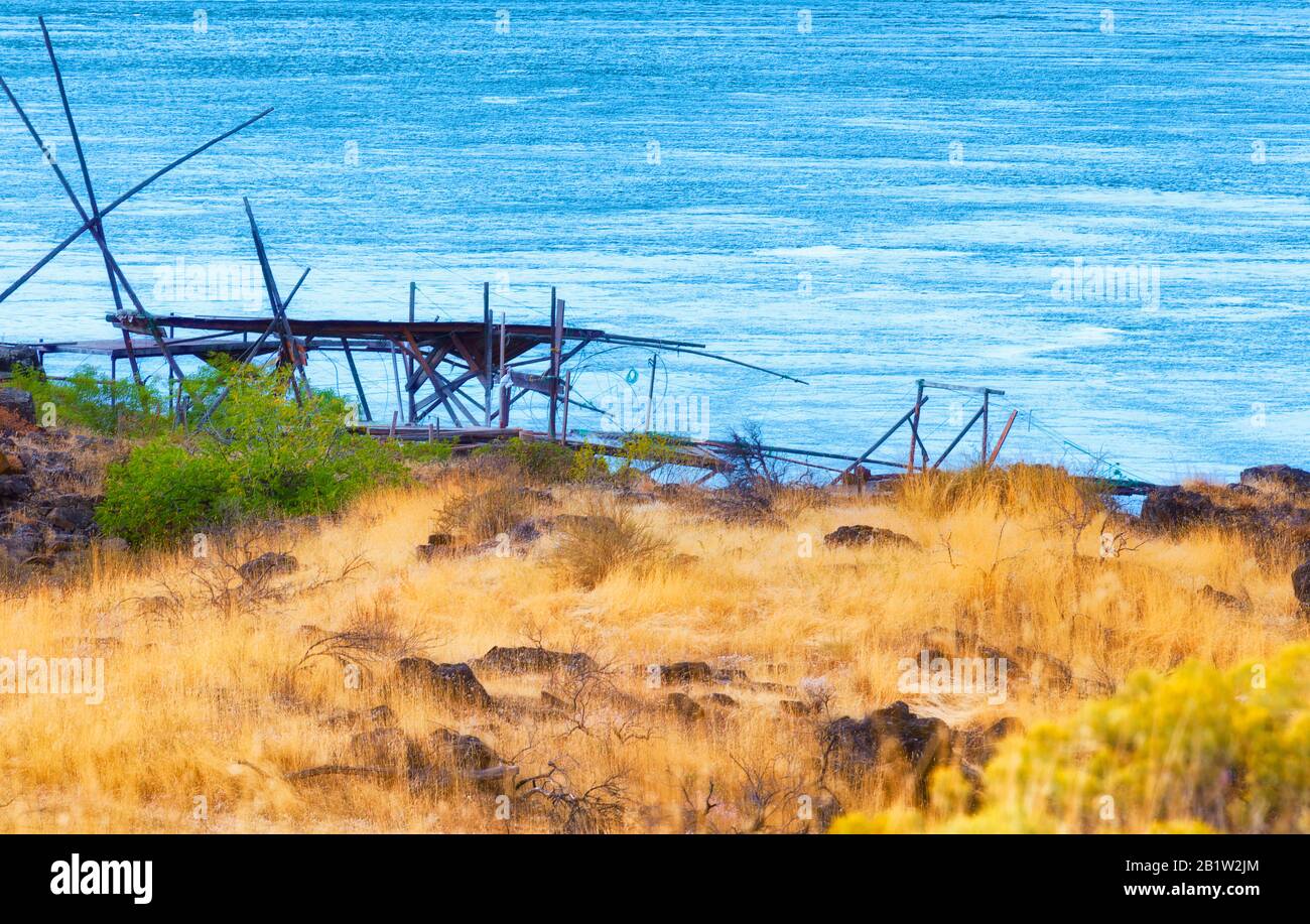 Indian fishing platforms line the shores of the Columbia River in The