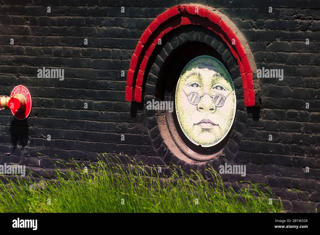 The Dalles, Oregon USA - May 11, 2014: Close up of sunshine faces on the side of the Sunshine Mill Winery Building which use to be a grainery, in The Stock Photo