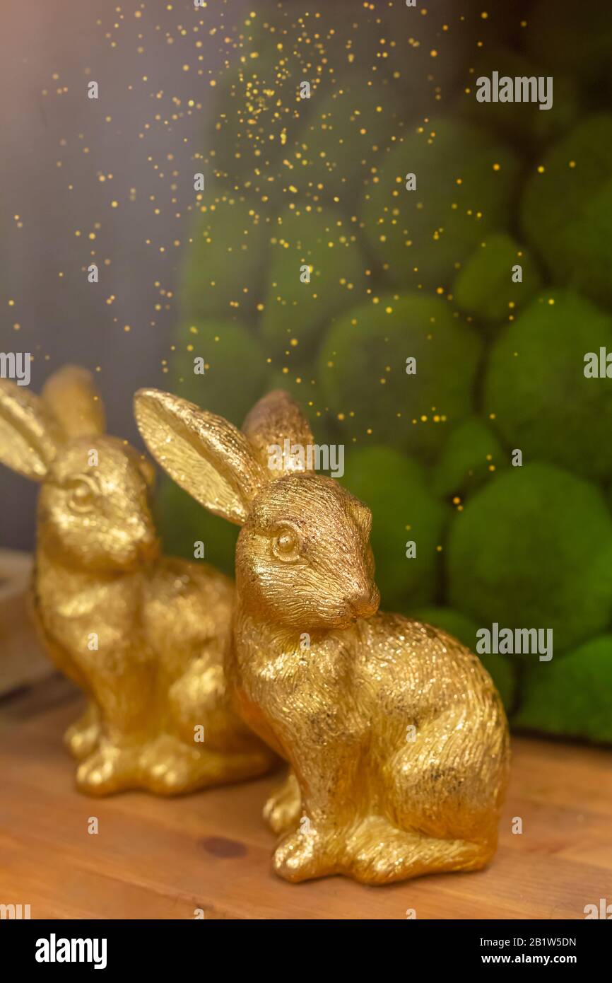 Golden rabbits on wooden background, Easter greeting card concept ...