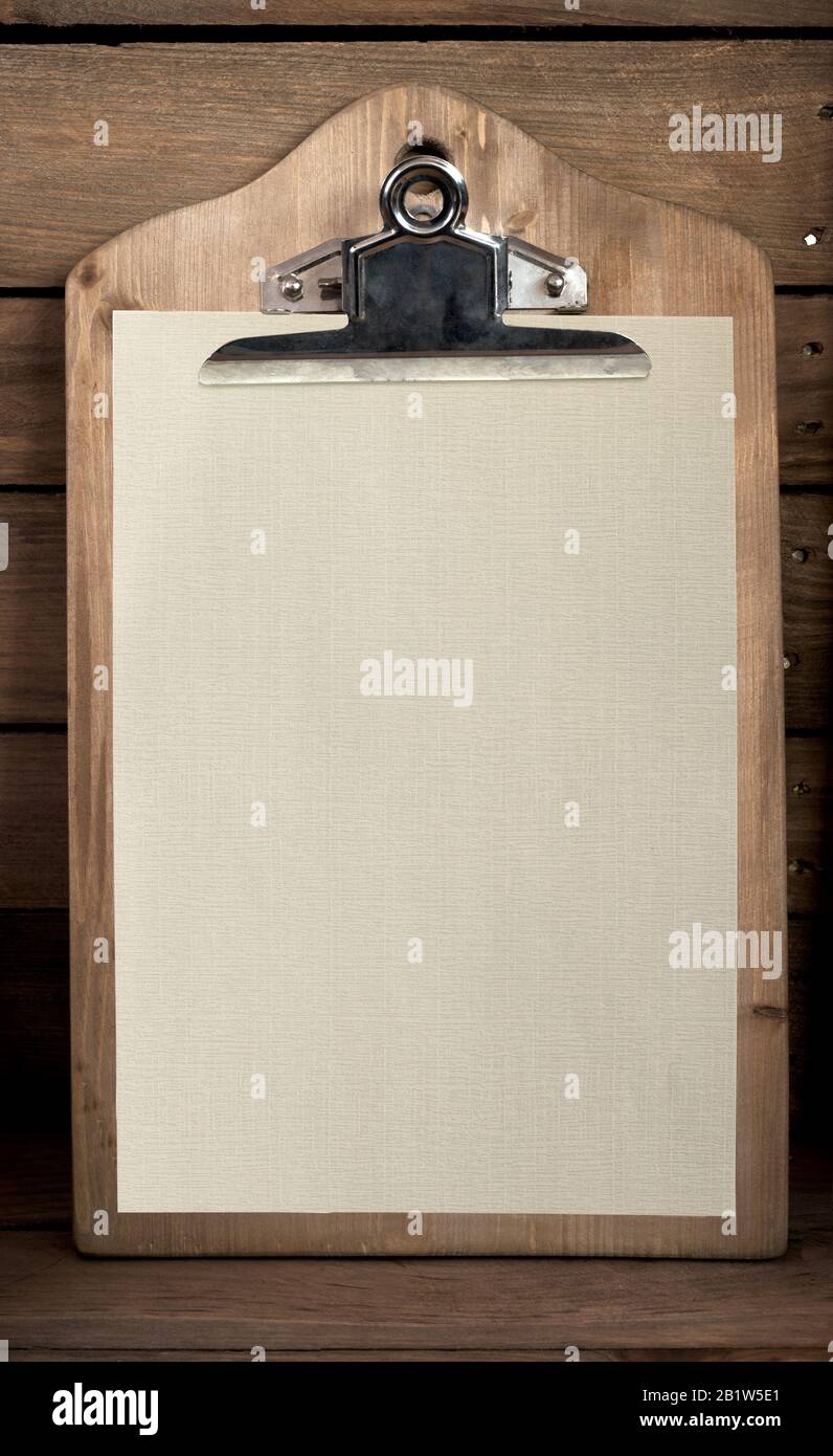 wooden clipboard with wood background and textured sheet Stock Photo