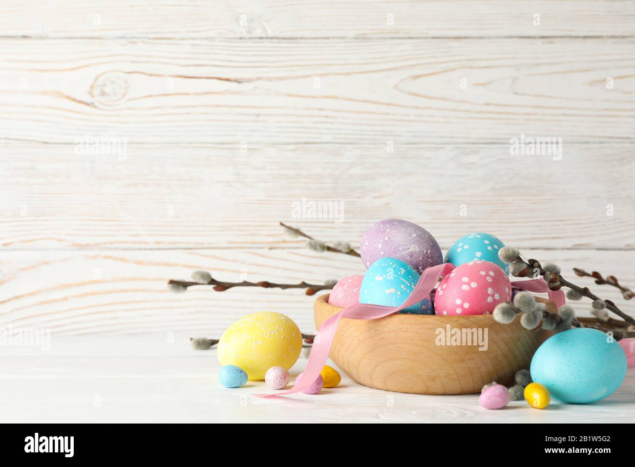 Composition with Easter eggs on white wooden background, space for text Stock Photo