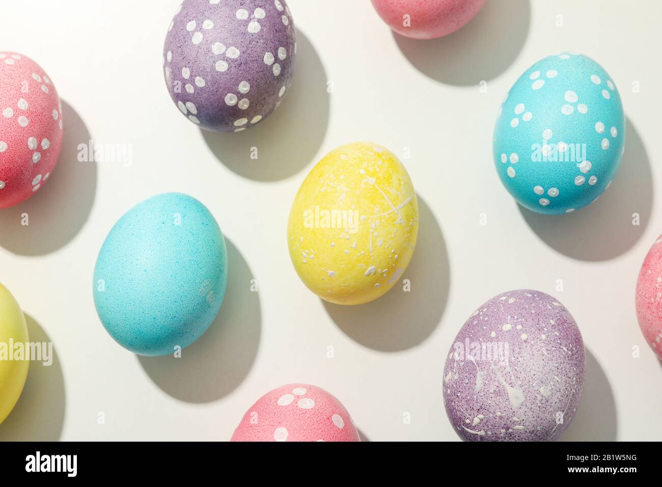 Flat lay. Multicolor Easter eggs on white background Stock Photo