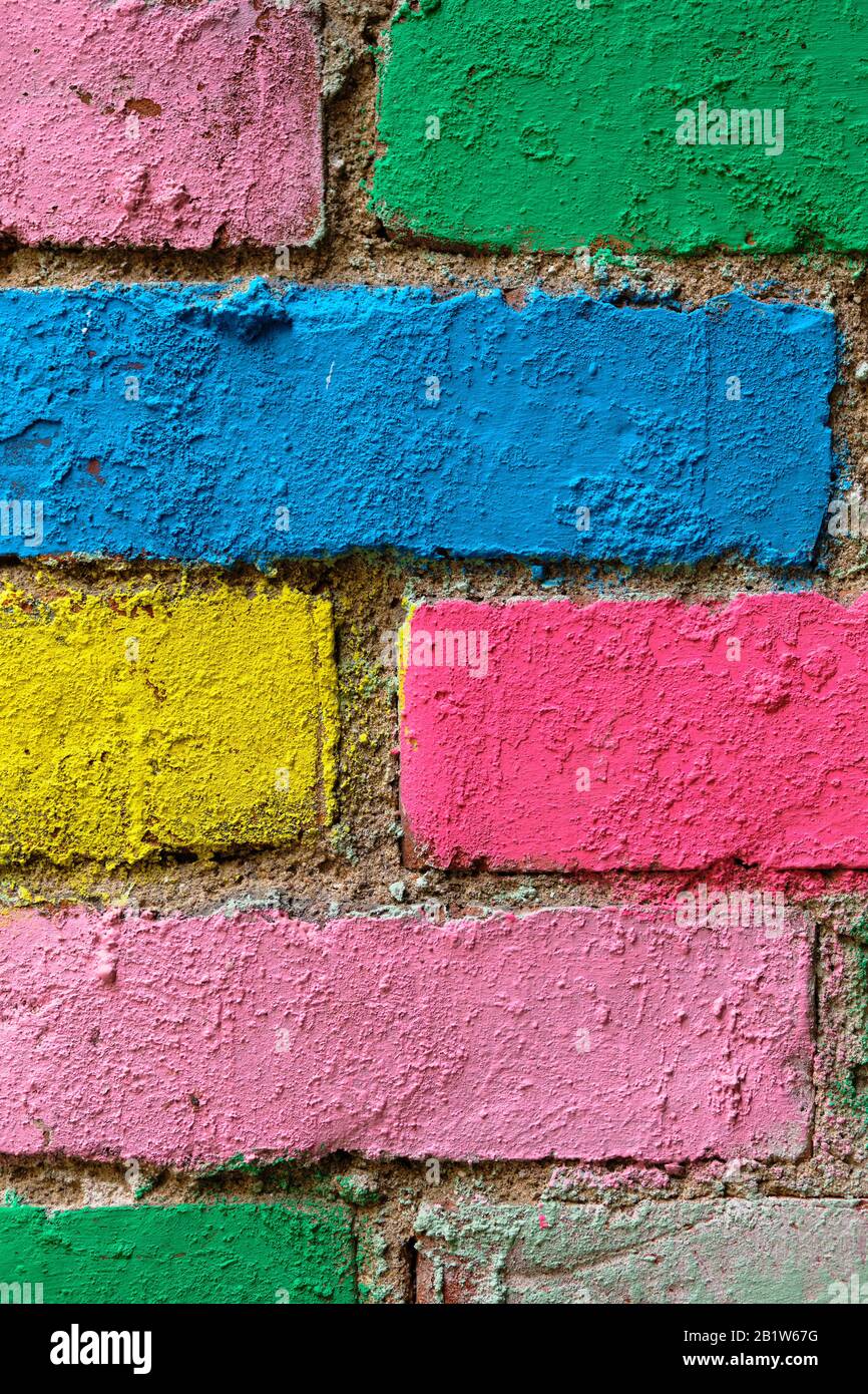 brick wall in different colors painted. Vertical. Close up. Stock Photo